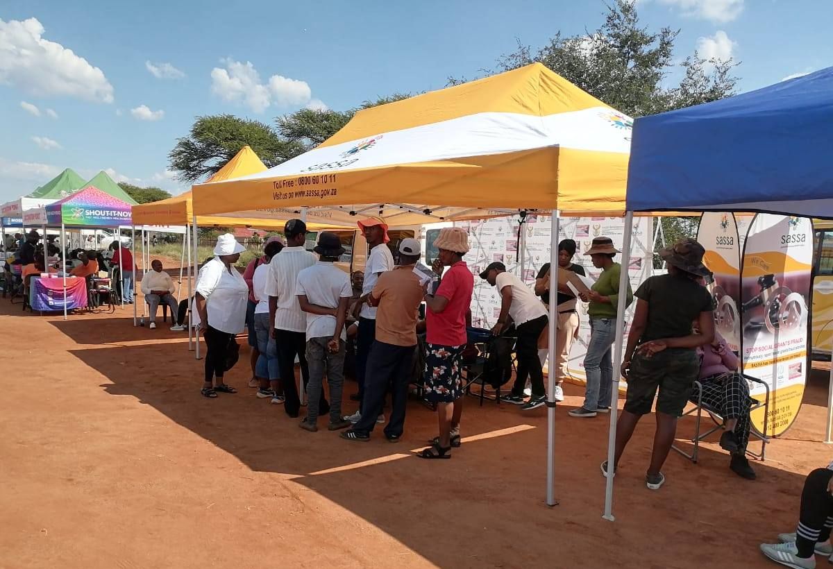 1.7 Million SASSA Grants at Risk Amid Postbank Dispute, Beneficiaries waiting in line for assistance at SASSA mobile units