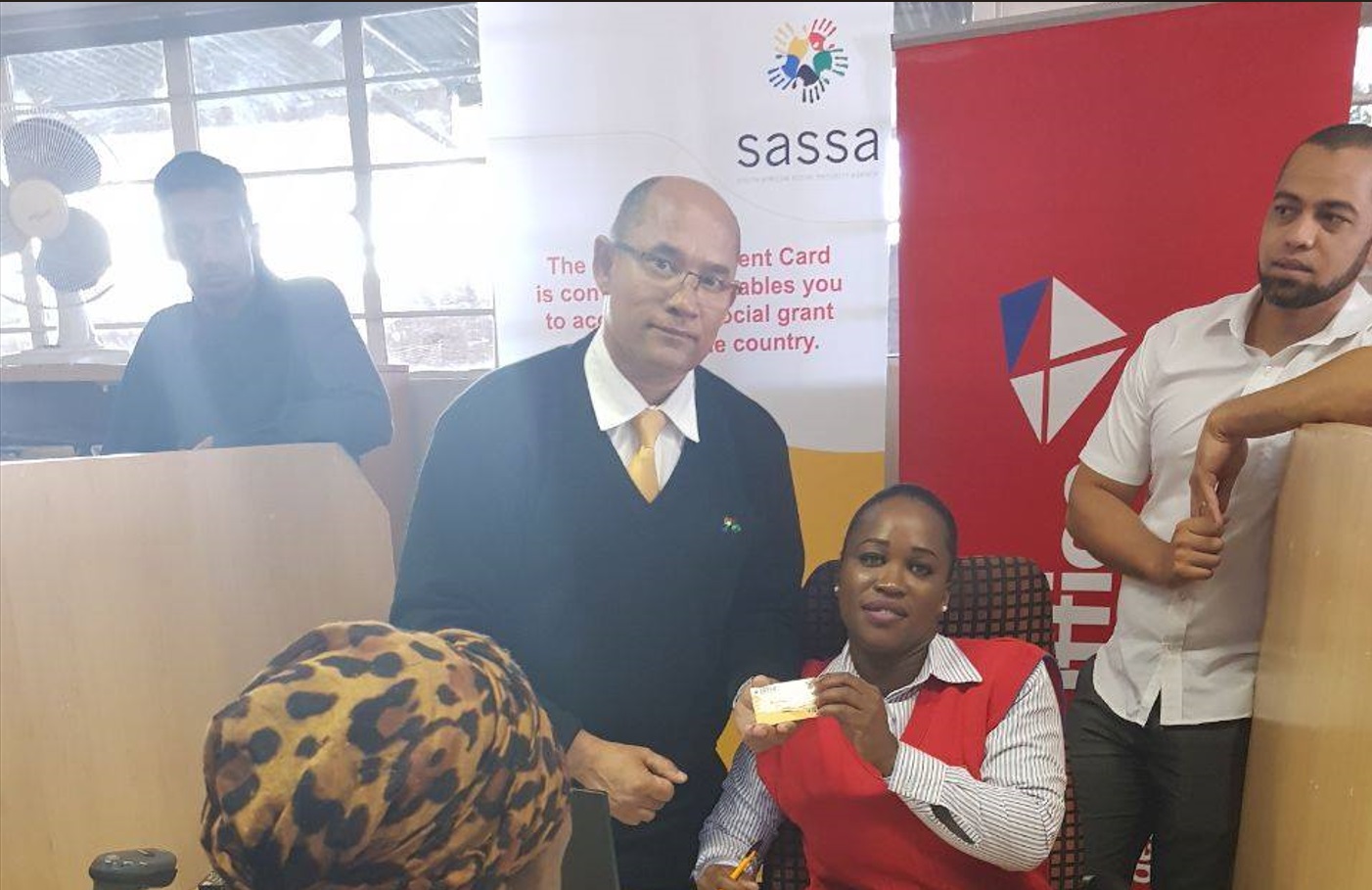 Postbank officials assist SASSA beneficiary in transitioning from Gold Card to new Black Card at Postbank office