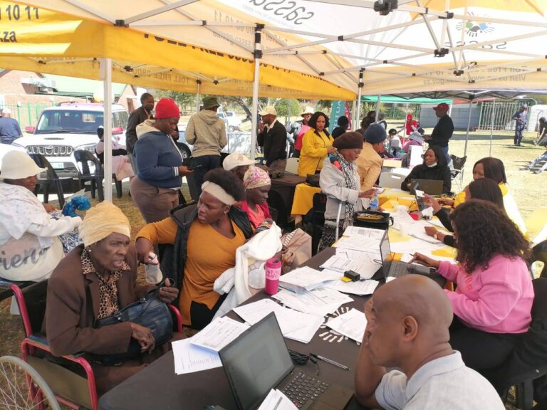South African parents and caregivers verifying children's birth certificates at a SASSA mobile desk to receive the child support grant, July 2025 SASSA Child Support Grant Status Check: Payment Date