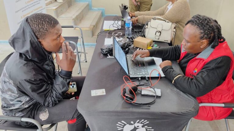 SASSA representative assists a concerned beneficiary who lost his phone number and is updating his contact details at the local SASSA office, Update Your Phone Number Now or Miss Your SASSA Grant in July 2025